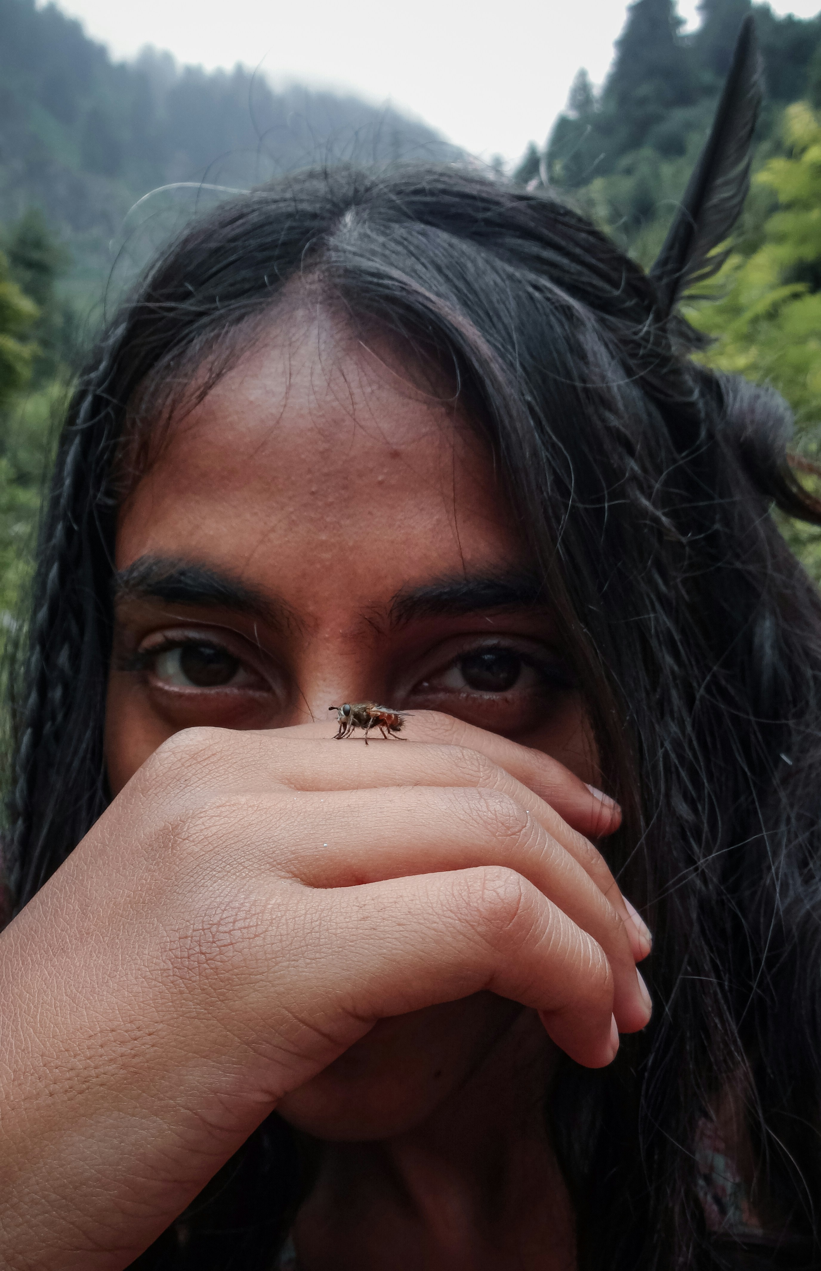 a woman with a bug on her face