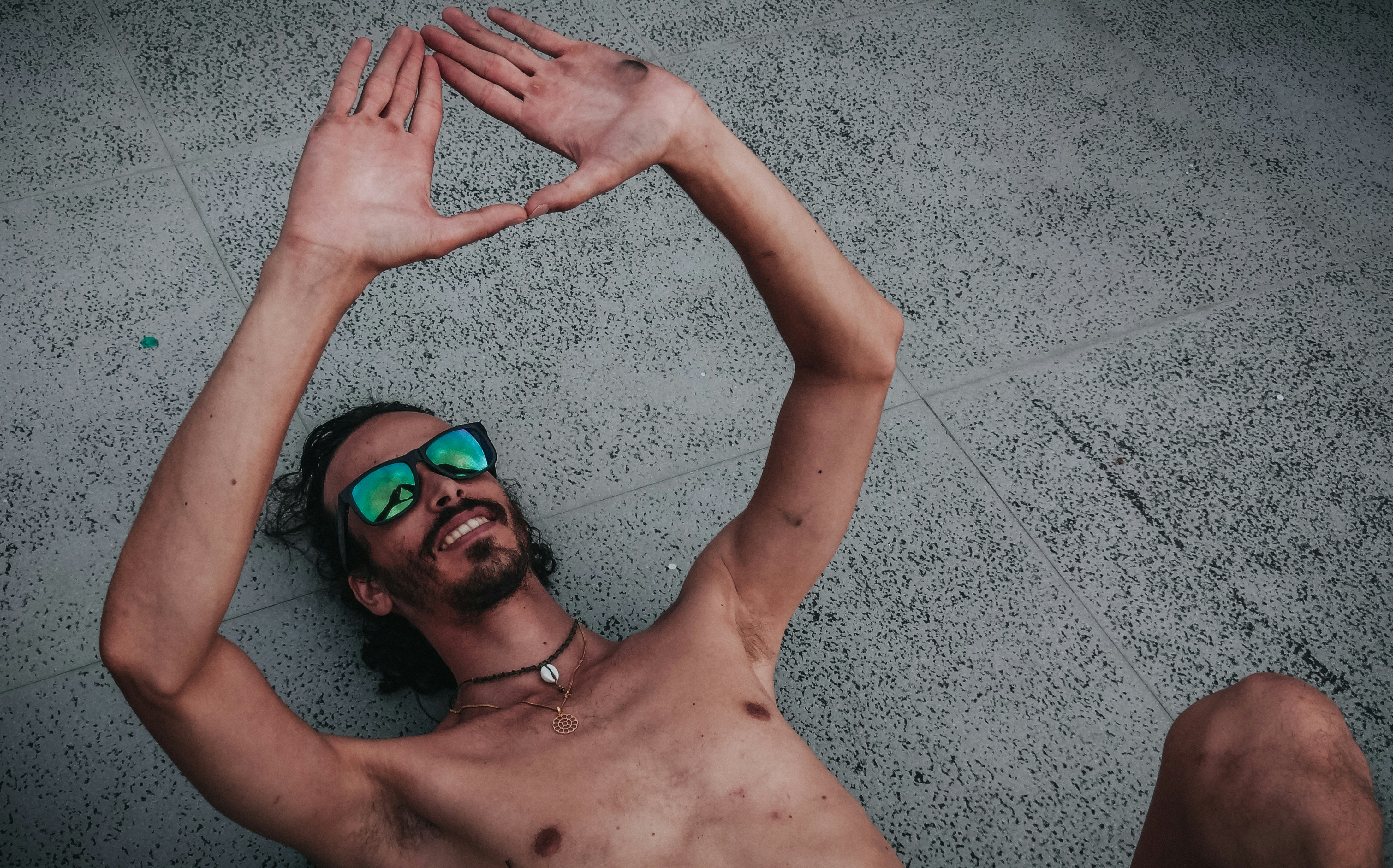 a person lying on the ground with the hands up