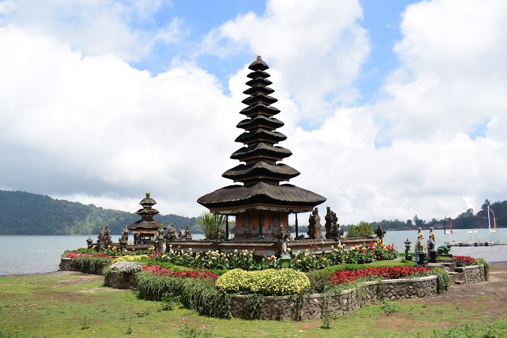 Bali with a tower and a body of water in the background