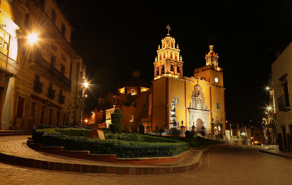 a street with buildings and lights at night