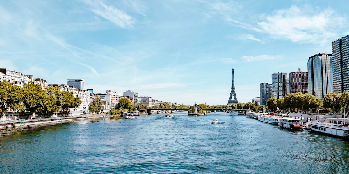 The Seine from Pont Mirabeau, with moored boats, riverside towers and the Eiffel Tower in the distance