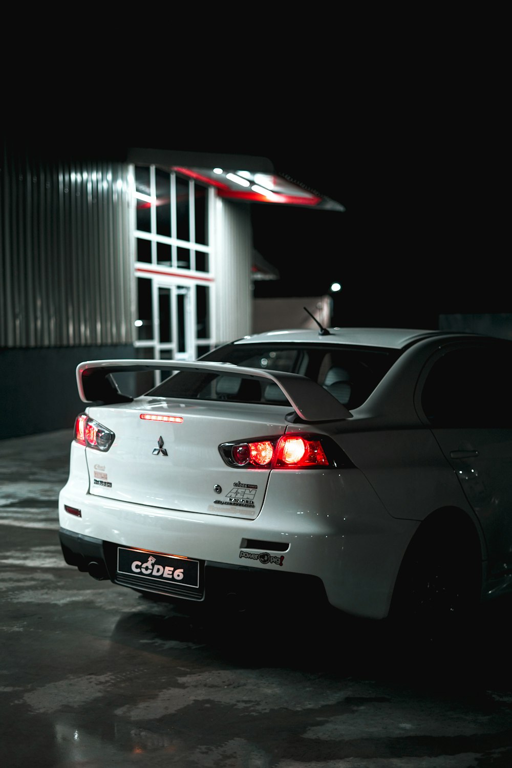 a car parked in front of a building at night