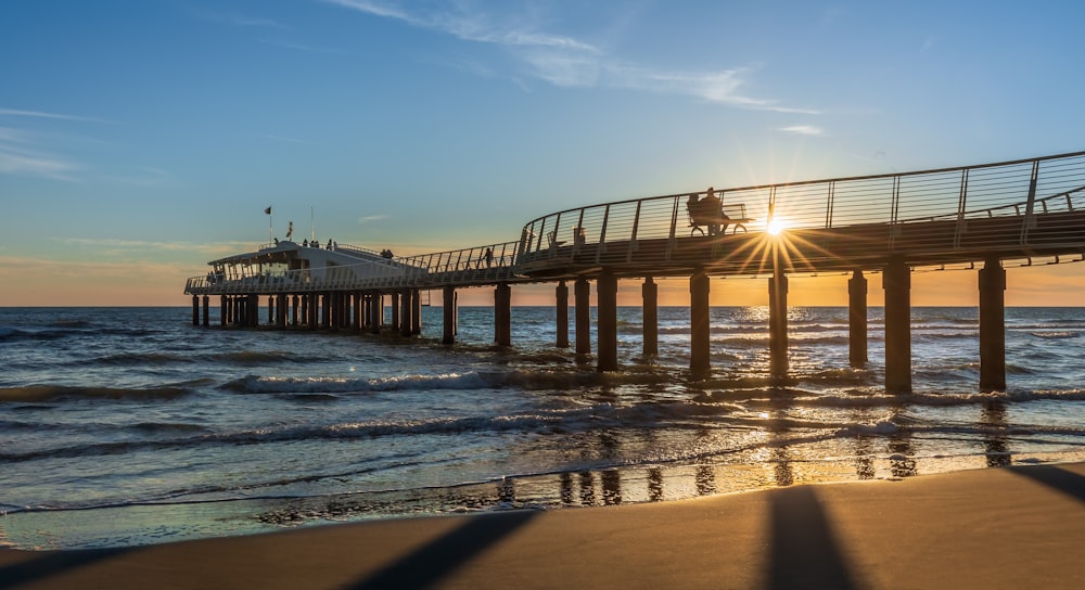 a long wooden pier over the ocean