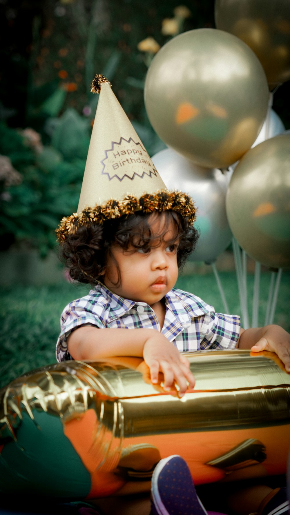 a child wearing a birthday hat