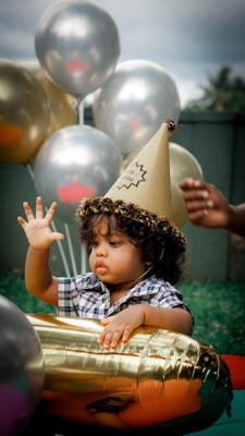 a child in a bucket with balloons