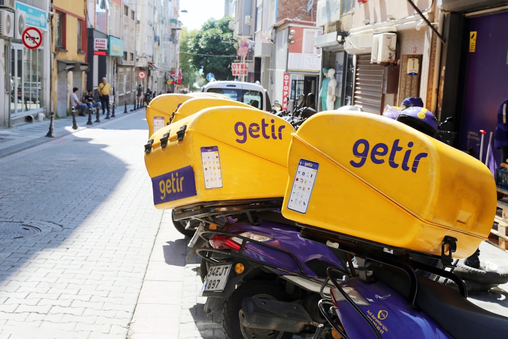 a yellow and blue motorcycle parked on the side of a street