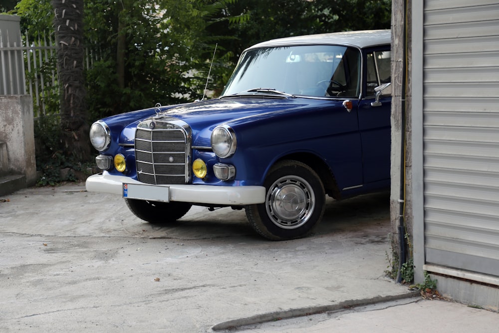 a blue car parked in a driveway