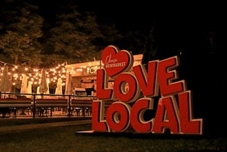 a sign with lights in the background