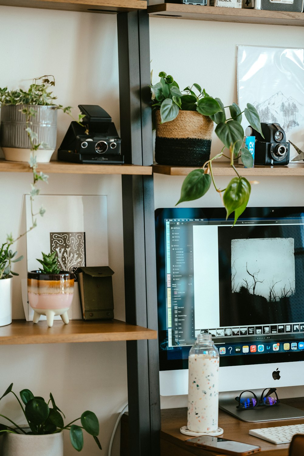 a computer monitor and camera on a desk