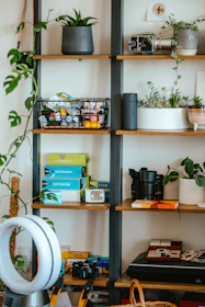 A variety of small electrical appliances neatly arranged on a shelf.