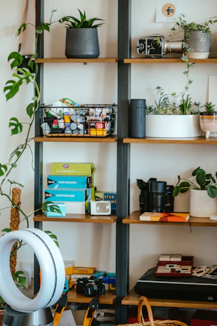Close-up of modern household electrical appliances neatly arranged on a shelf.