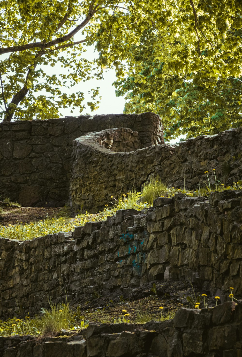 a stone wall with graffiti