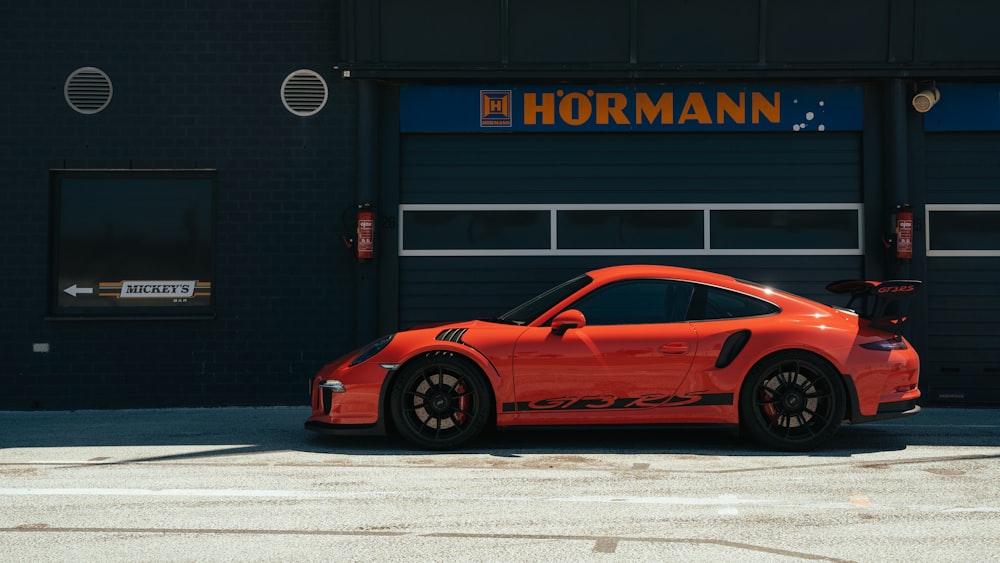 a red sports car parked in front of a building