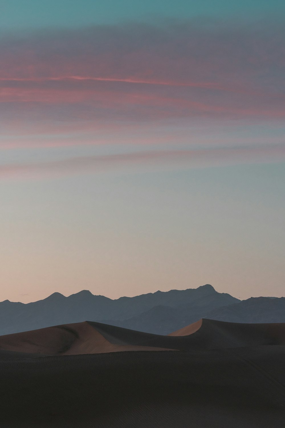 a landscape with hills and a blue sky