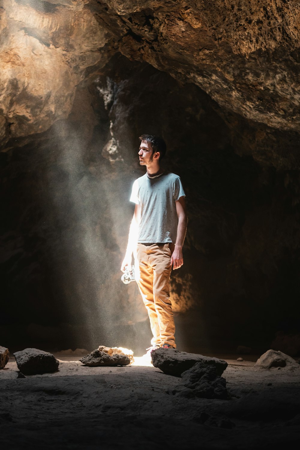 a man standing in front of a cave