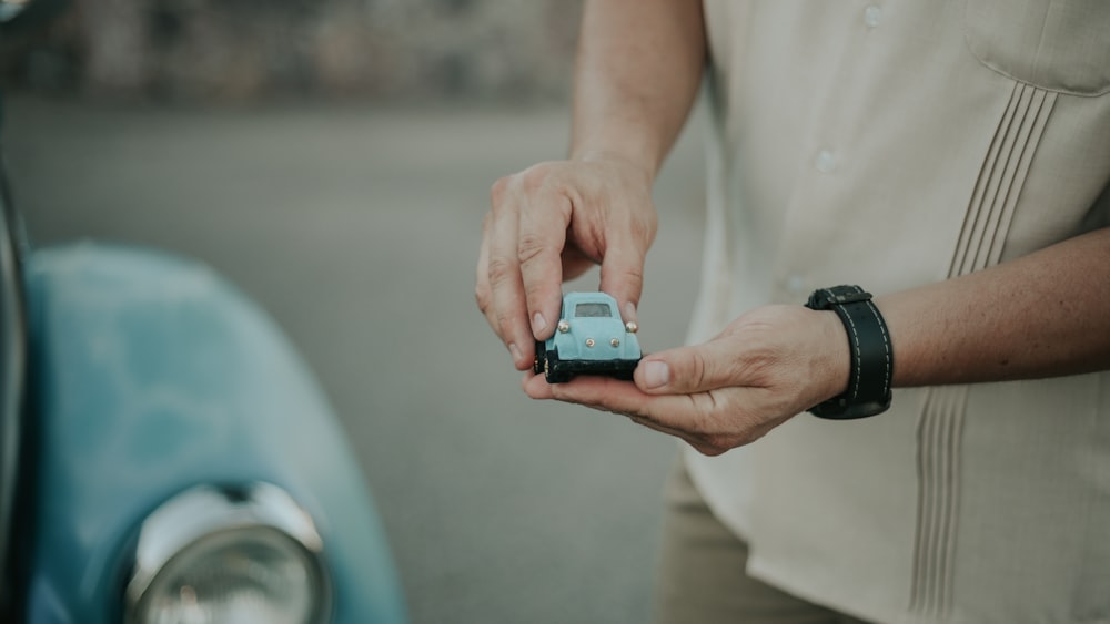 a person holding a small device