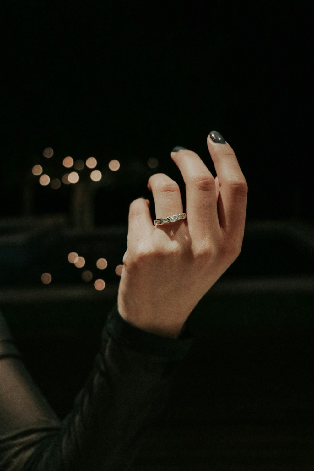 a person's hand with a ring on it