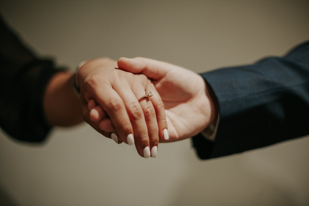 a close-up of hands shaking