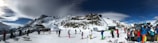 A panoramic view of the snow-covered Issarbe Altitude landscape with skiers and snowshoers enjoying winter activities.