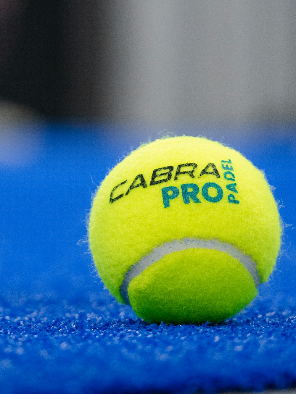a tennis ball with a yellow and black logo on it
