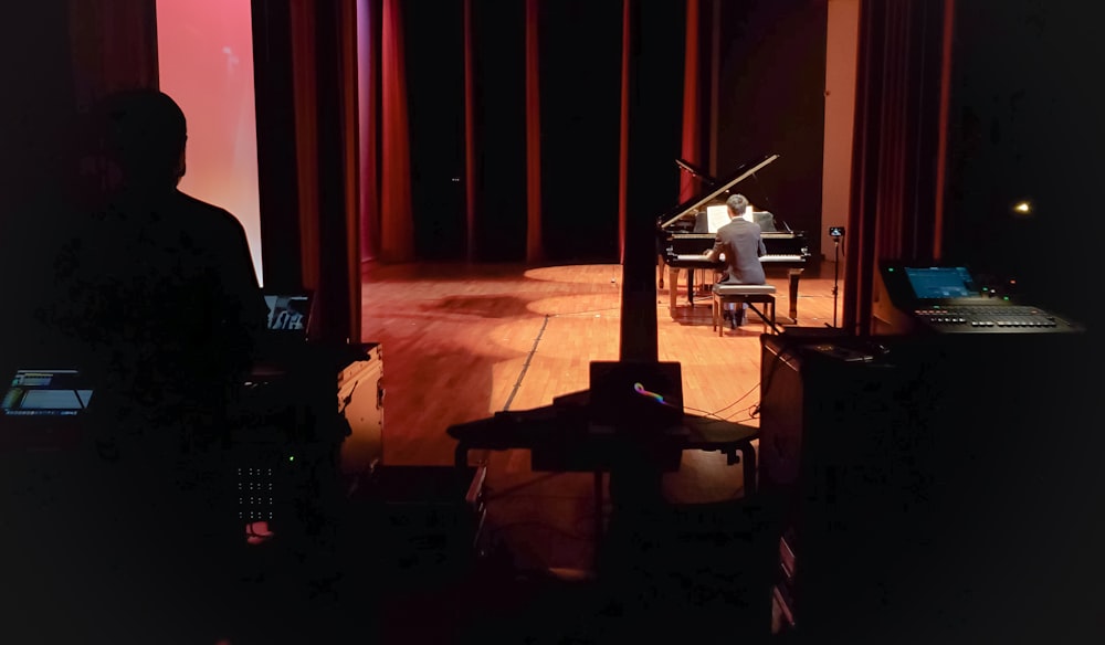 a person playing a piano on a stage