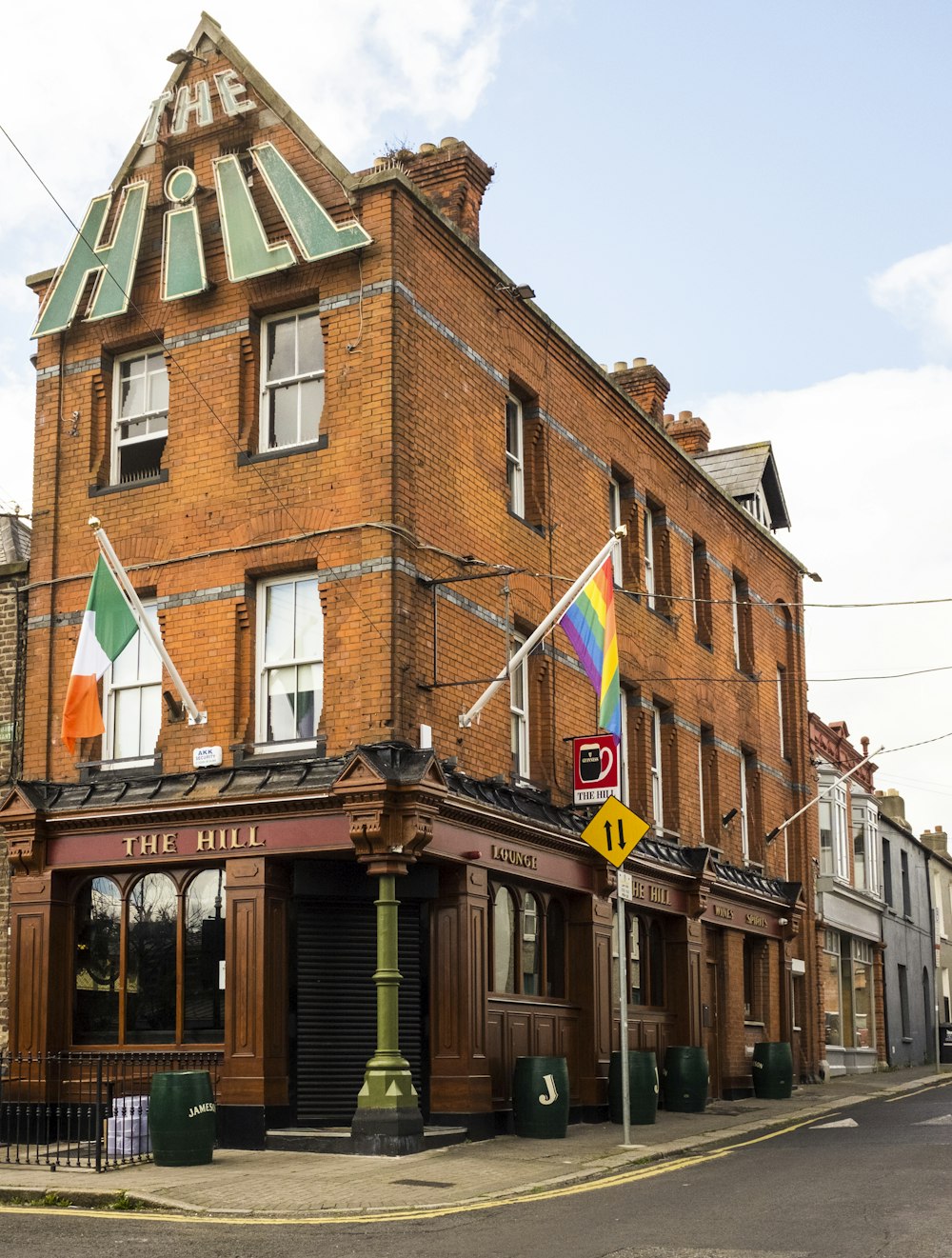 a brick building with flags