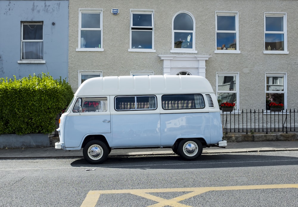 a white bus parked on the side of a street