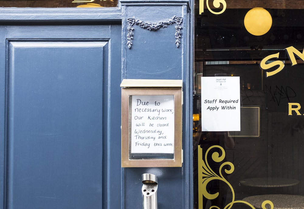 a blue door with a sign on it