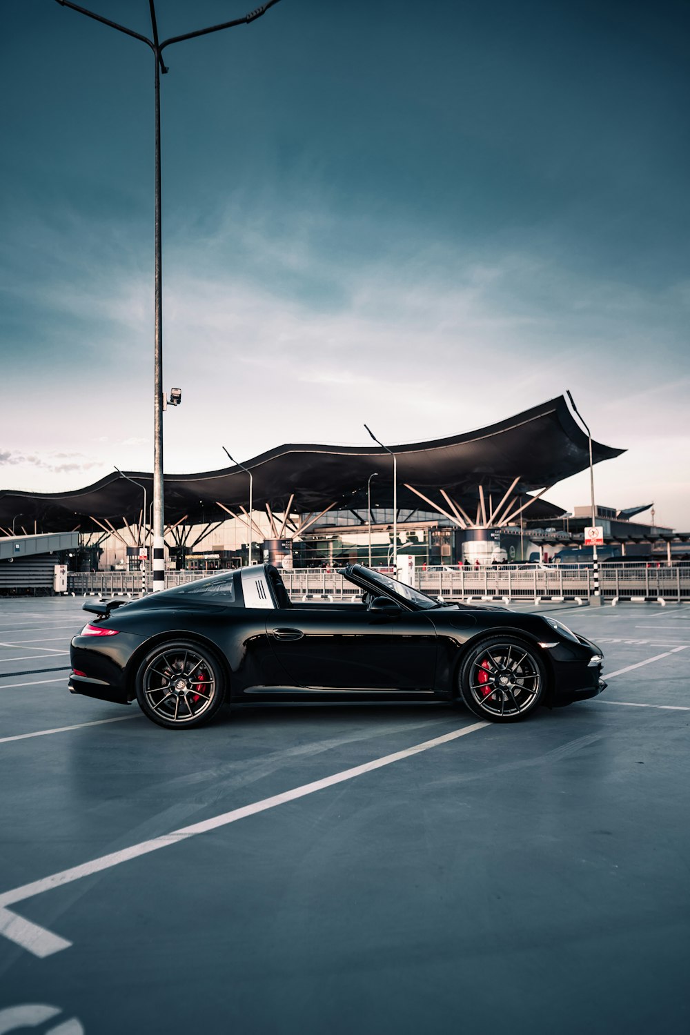 a black sports car parked in a parking lot