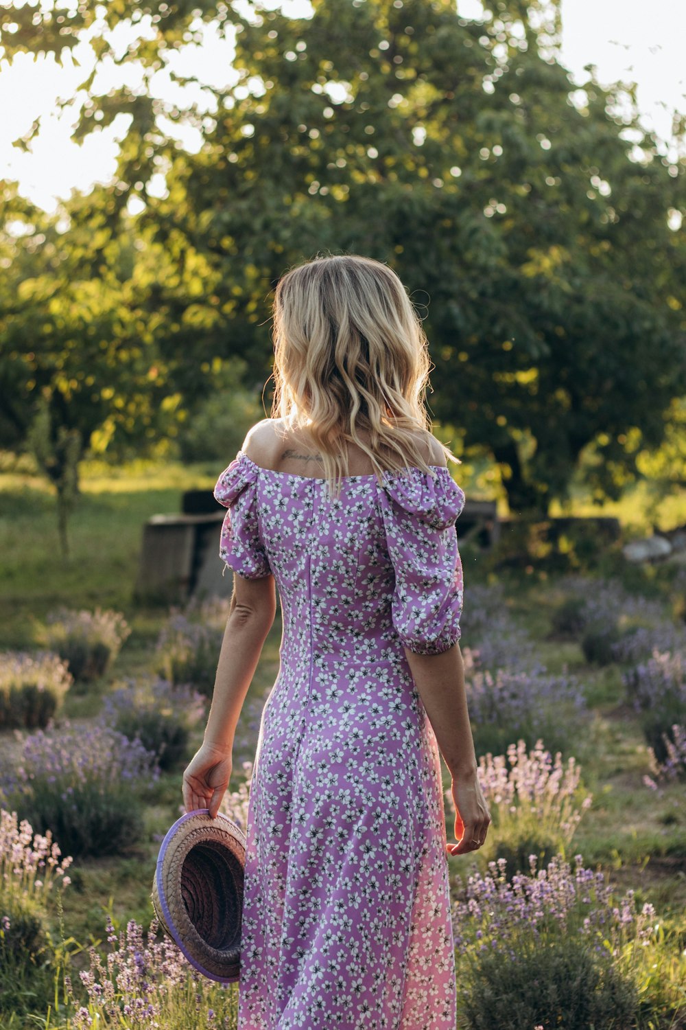 a person walking through a field of flowers