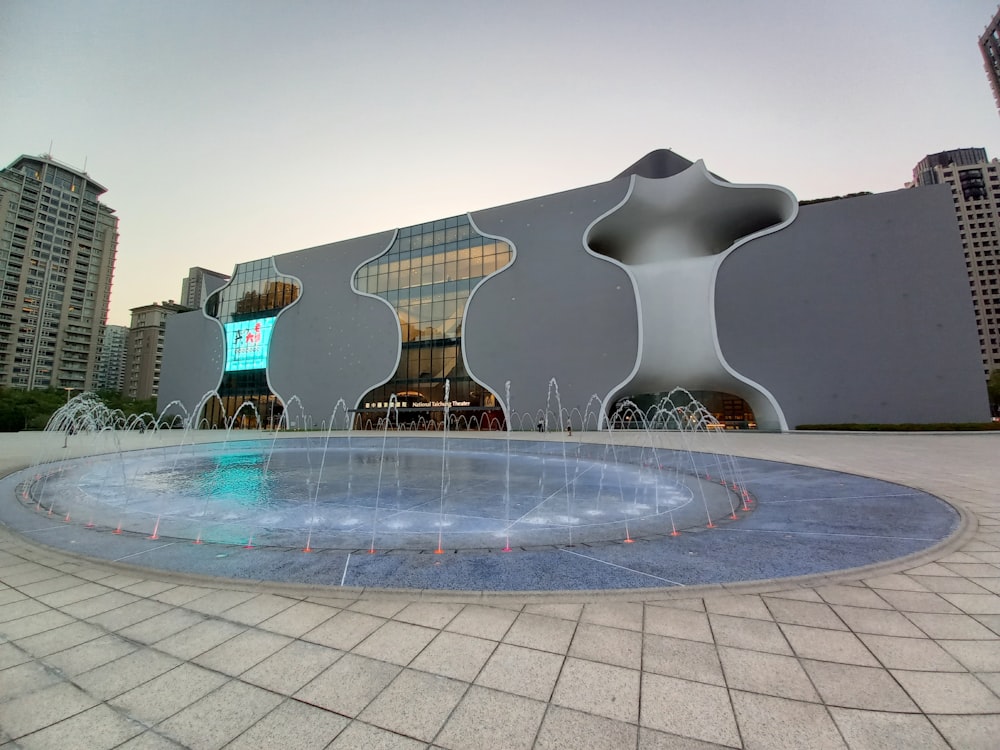 a large building with a fountain in front of it