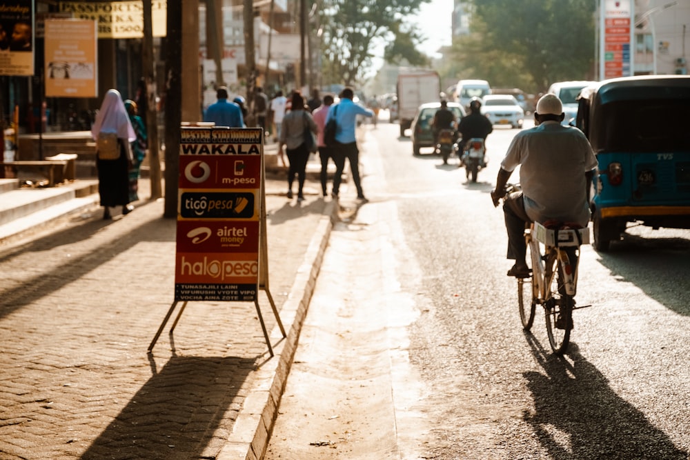 a person riding a bicycle down a street