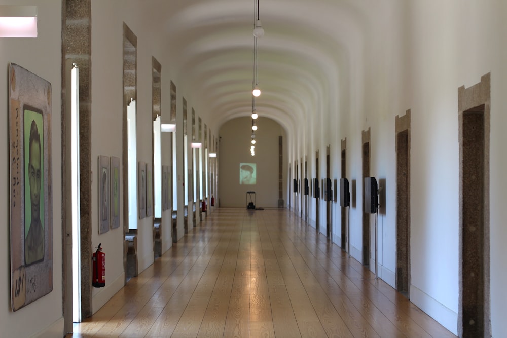 a long hallway with art on the walls