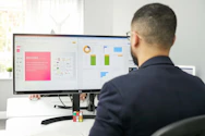 Portrait of Mazharul H., co-founder of Authitbd and Leadgenmaz Pro, working at his desk with dual monitors displaying lead data.
