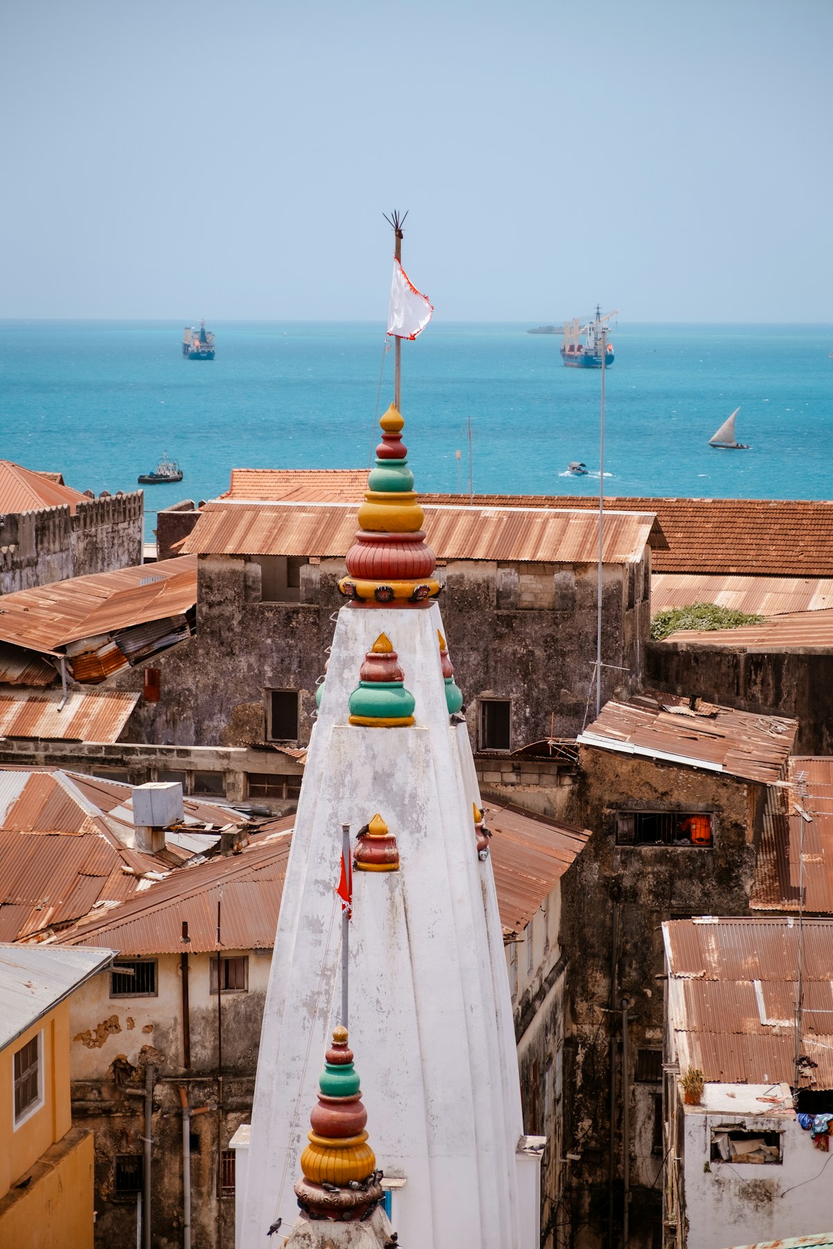 Zanzibar April — waterfront settlement with palm trees and rooftops in the long rains season