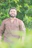 Man with a beard and casual shirt, outdoors with soft sunlight.