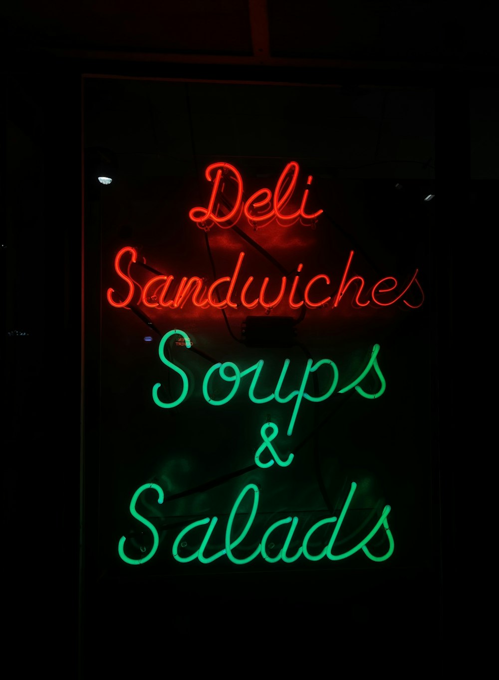 a neon sign with green text