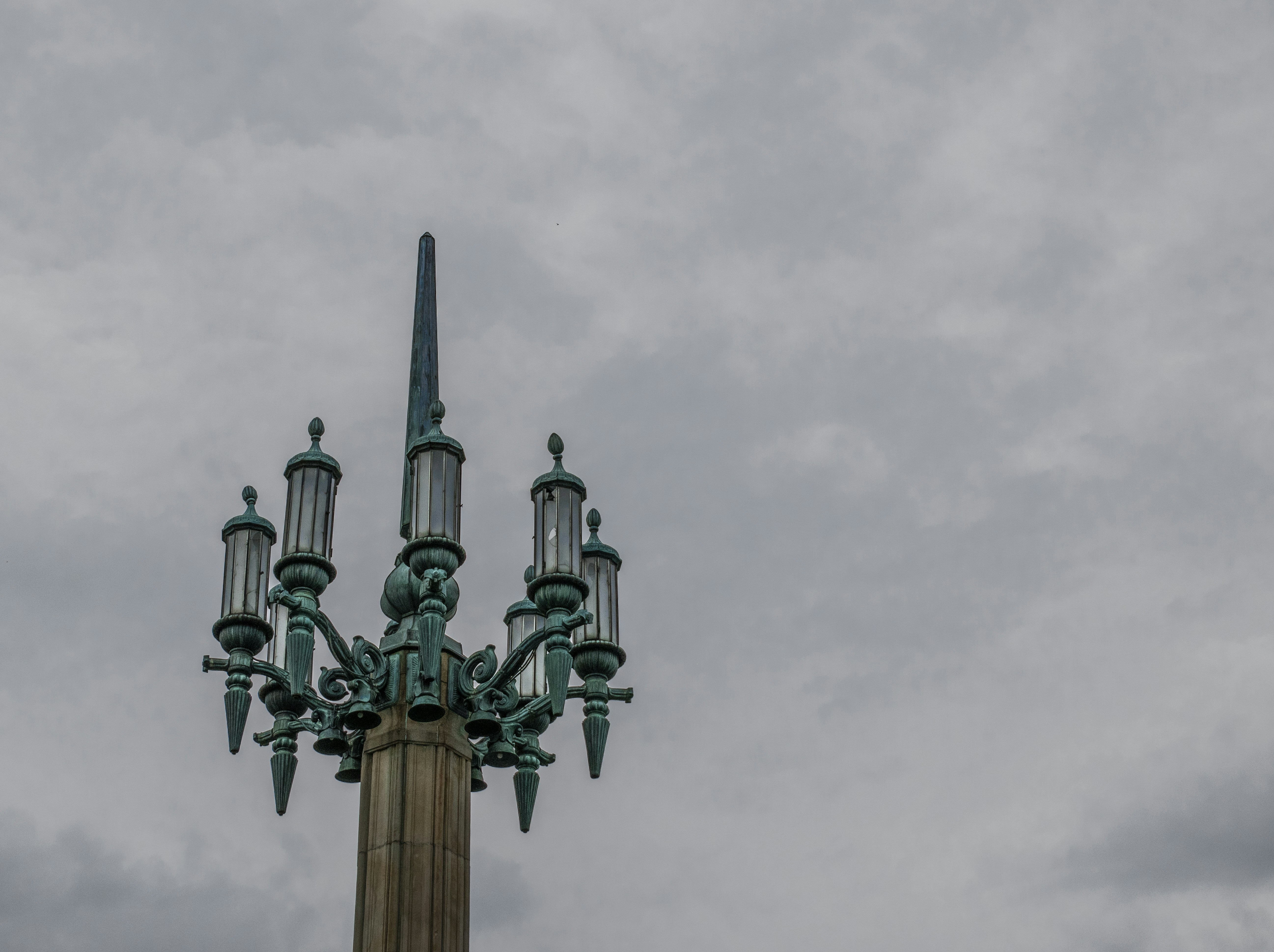 a tall tower with a statue on top