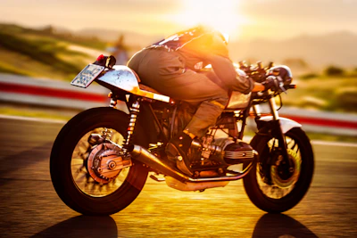 A cinematic shot of a high-performance motorcycle speeding on a winding racetrack at dusk.
