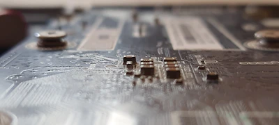 Detailed shot of electronic components like capacitors and resistors on a circuit board.