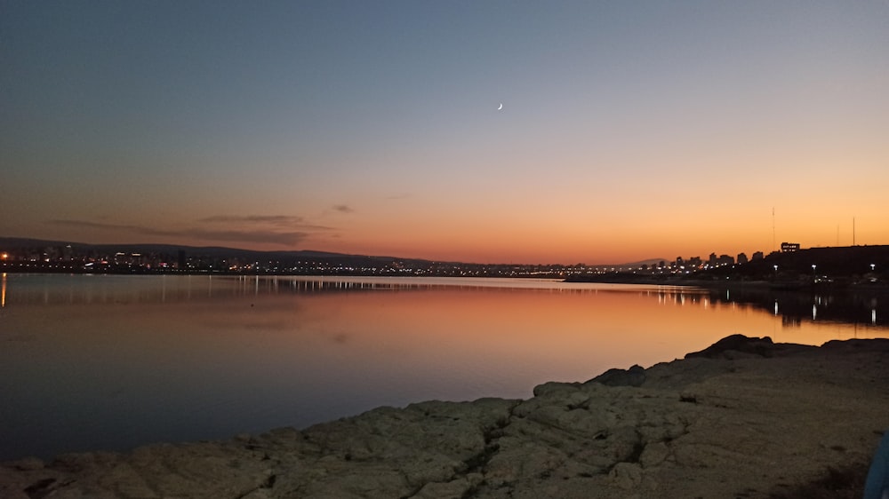 a body of water with a city in the background