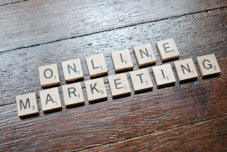 Scrabble tiles arranged to spell 'ONLINE MARKETING' on a wooden table with a textured surface.
