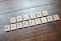 Scrabble tiles arranged to spell 'ONLINE MARKETING' on a wooden table with a textured surface.