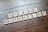 Scrabble tiles arranged to spell 'ONLINE MARKETING' on a wooden table with a textured surface.