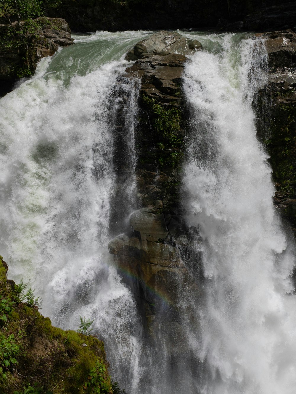 a waterfall with trees and rocks