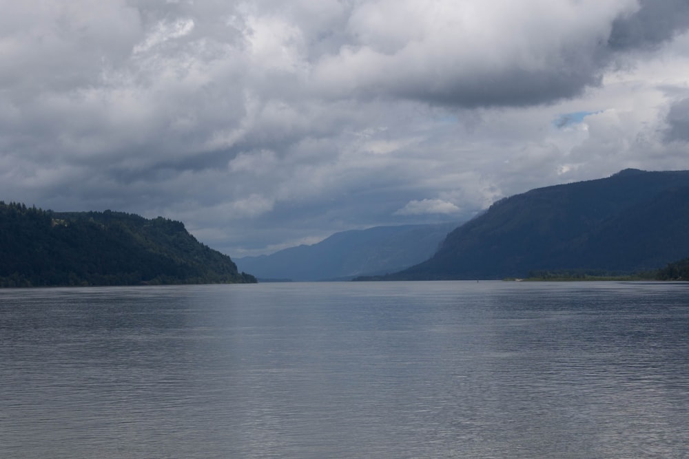 a body of water with mountains in the background