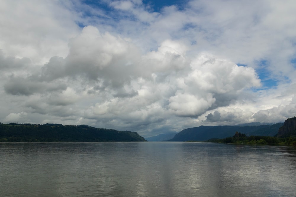 a body of water with mountains in the background