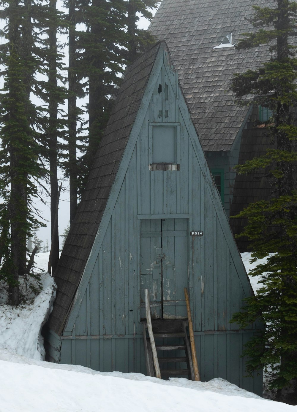 a blue barn in the snow