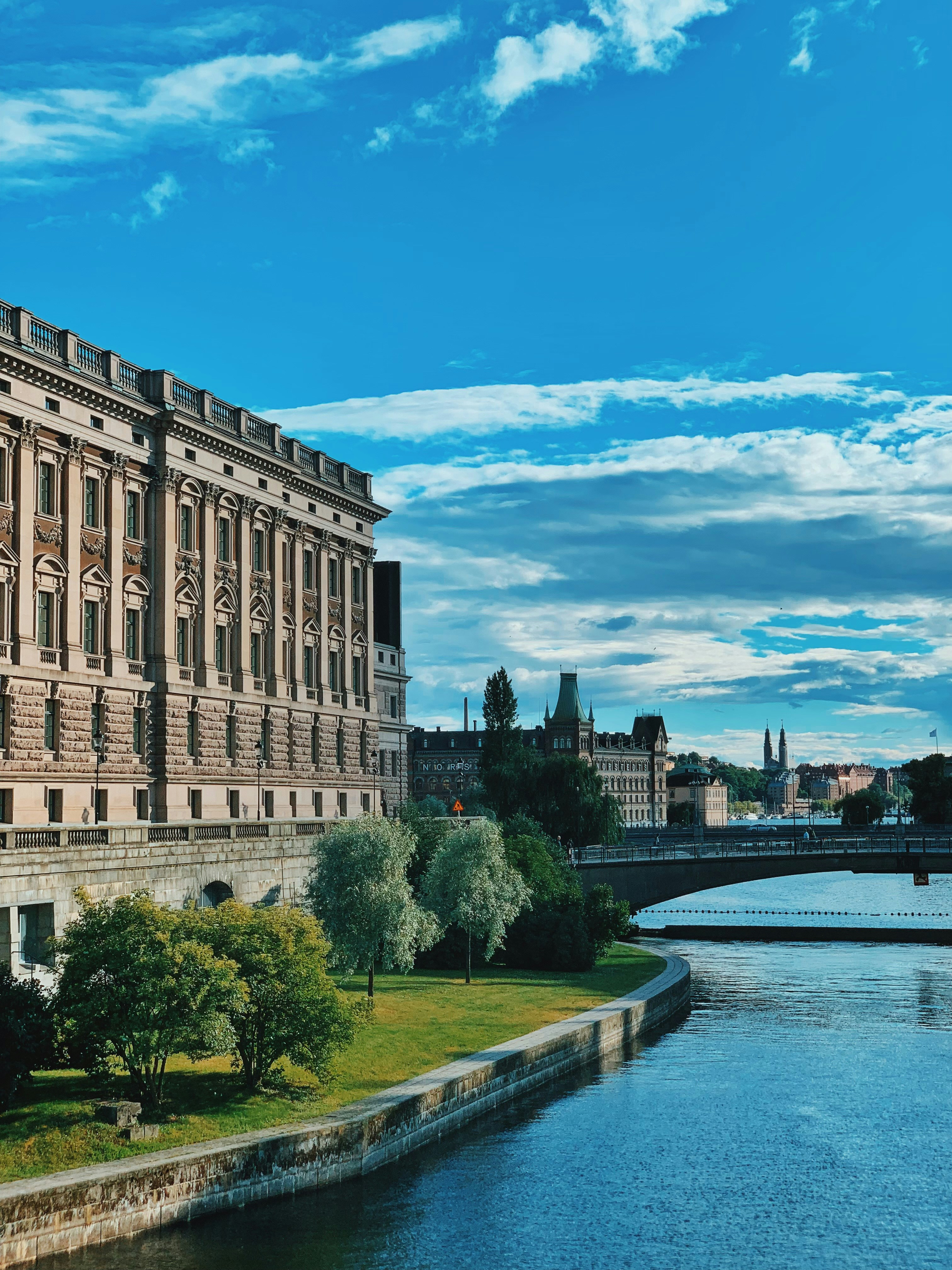 a river with a bridge and buildings along it