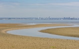 a beach in Ryde with a city called Portsmouth in the background